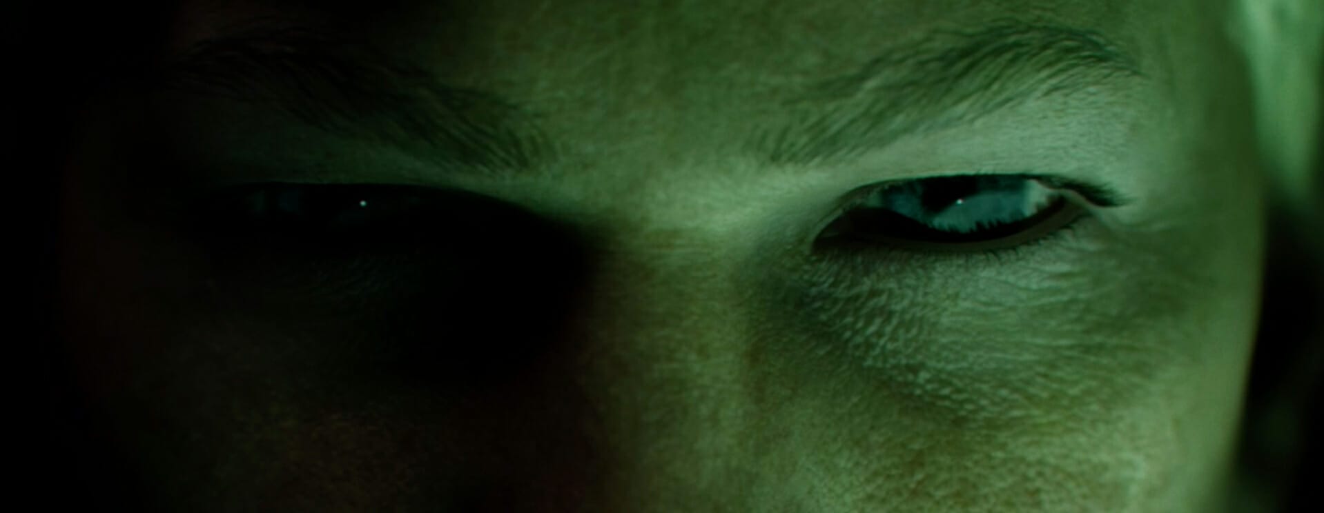 Intense close-up of an eye, set against a dark background. The text 